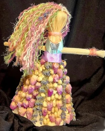 Doll of the goddess Aisling: pastel yarn hair and a skirt of rosebuds and lavender