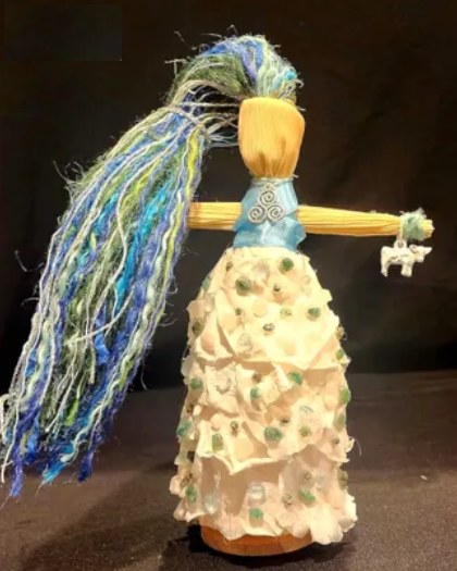 Doll of the goddess Boann: blue and green yarn hair and a white flowing skirt