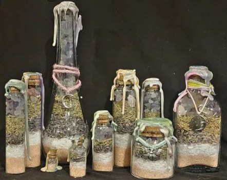 Joy spell jars: a group of tall and short jars with pastel wrapping