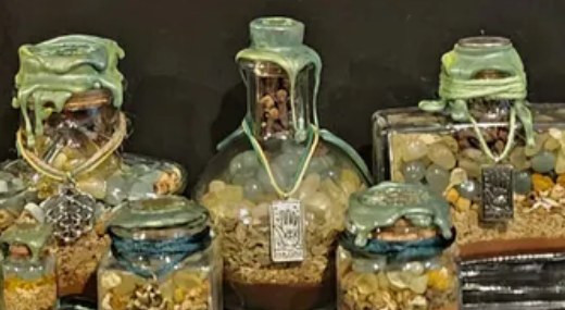 Prosperity spell jars: a group of green-wrapped jars