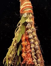 A 6-inch mini-besom of dried herbs and flowers in orange and green