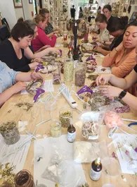 A long table of guests making wreaths together