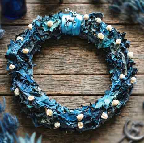Yule and Cailleach wreath of indigo and dried botanicals with a silver reindeer charm